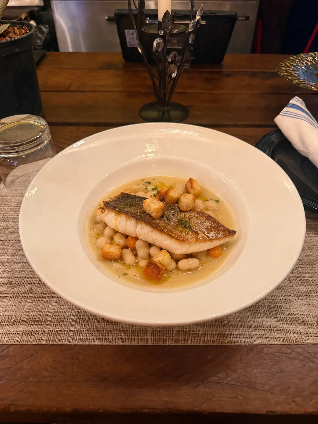 Branzino &mdash; Fasolada, velouté, croutons. Golden skin. Warm broth. Quiet luxury.